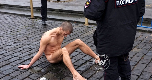 A Russian artist nails his genitals to the ground